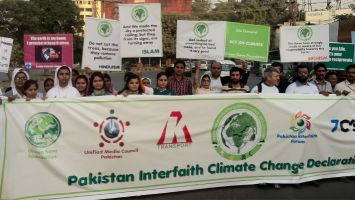 People hold signs during ecological protest in Pakistan