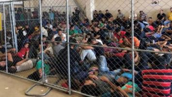 An overcrowded, fenced area holds families at a Border Patrol station in McAllen, TX, on 10 June 2019 (Thomas Cizauskas).